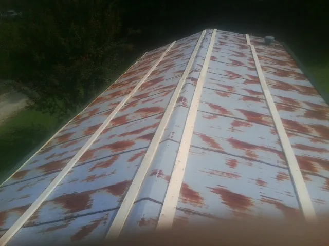 Rusted metal roof panels with new wood purlins before replacement — Storm Damage Roof Repair in Tamworth by Roofing Brothers